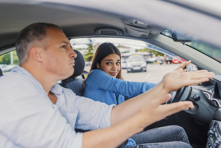 Woman getting a driving lesson in the car